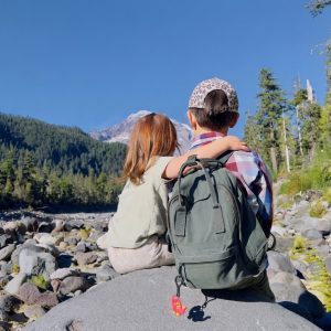 Two kids looking up at mountain